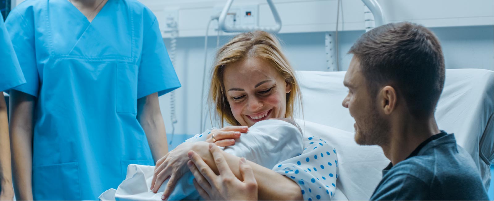 Mother and Father holding their new born baby